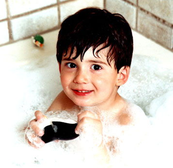 Boy tortures promotional penguin: Jeff in tubby bubbles, twisting the head off a penguin