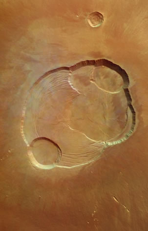 Olympus Mons caldera: The caldera at the summit of Olympus Mons on Mars, photographed by Mars Express. Olympus Mons has an elevation of 24 km relative to the surrounding surface (three times Mt Everest) and the caldera has a depth of about 3 km